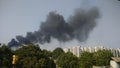 Dense black fire cloud in a city Royalty Free Stock Photo