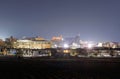 Dense buildings brightly lit on edge of town at night Royalty Free Stock Photo