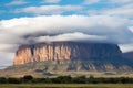dense cloud cover over flat-topped rock formation