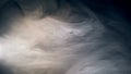 Dense clouds of smoulder flowing against dark background