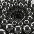 A dense cluster of reflective metal spheres forming a spiral pattern, creating a mesmerizing visual effect Royalty Free Stock Photo