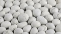 A dense collection of smooth, rounded white pebbles and stones arranged closely together, creating a textured and Royalty Free Stock Photo