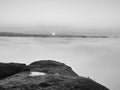 Dense fog in deep valley in Saxony Switzerland full of heavy clouds. Sandstone peaks increased from foggy background, the Sun Royalty Free Stock Photo