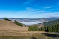 Dense fog hiding a small village at  valley ,late November, view from the top of the mountain Royalty Free Stock Photo