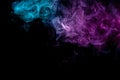 Abstract art colored blue and pink smoke on black isolated background. Royalty Free Stock Photo