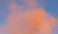 dense orange noxious smoke rises high and the blue sky