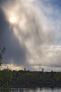 Through the dense storm clouds breaks the sun. View of the Hydropark and the right bank of the Dnieper River. Kyiv. Ukraine