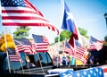 Dense of Texas and American flags on cargo bed of modern pickup truck driving on residential street smalltown Fourth of July Royalty Free Stock Photo