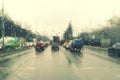 Dense traffic on a rainy day. Traffic in rainy day with road view through car window with rain drops. Blurry image, Rain drops on Royalty Free Stock Photo