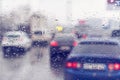 Dense traffic on a rainy day. Traffic in rainy day with road view through car window with rain drops. Blurry image, Rain drops on Royalty Free Stock Photo