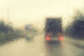 Dense traffic on a rainy day. Traffic in rainy day with road view through car window with rain drops. Blurry image, Rain drops on Royalty Free Stock Photo