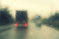 Dense traffic on a rainy day. Traffic in rainy day with road view through car window with rain drops. Blurry image, Rain drops on Royalty Free Stock Photo