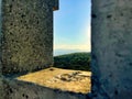 Dense trees seen from a concrete wall window in Bad Voslau, Austria Royalty Free Stock Photo