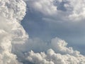 white clouds contrast with grey couds