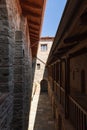 Densely packed sandstone masonry buildings house the monks` cells and wooden shaded gallery. The Holy Monastery of Great Meteoron