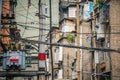 Densely wired telephone and electric cables outside residential buildings Royalty Free Stock Photo