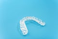 Dental aligner used by dental doctors isolated on blue background