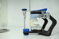 dental articulator with dental gypsum prosthesis model in dental laboratory An articulator used in dental laboratories