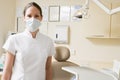 Dental assistant in exam room with mask on