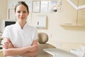 Dental assistant in exam room smiling