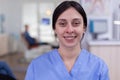 Dental assistant looking at camera in waiting area