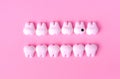 Dental background with models of teeth in two lines. One tooth with caries Royalty Free Stock Photo