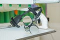 The dental binocular loupes on white tablel in dental office. Dentist goggles, protective glasses in dentist`s office