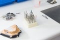 Dental burs and dental articulator in a lab. Royalty Free Stock Photo