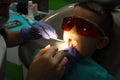 Dental care check up. Dentist examining and doing teeth treatment in dental clinic. A little boy on a dental chair Royalty Free Stock Photo