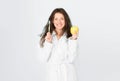 Dental care. Oral hygiene. Woman bathrobe hold toothbrush and apple. Personal hygiene. Girl cleaning teeth. Freshness