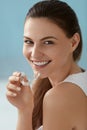 Dental care. Smiling woman using removable clear teeth braces