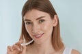 Dental care. Smiling woman using removable clear teeth braces