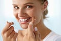 Dental Care. Woman With Beautiful Smile Using Floss For Teeth Royalty Free Stock Photo