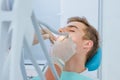 Dental caries prevention.Teenage boy at the dentist`s chair during a dental procedure, smile close up. Healthy Smile. Royalty Free Stock Photo