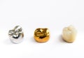 Dental ceramic, gold and metal tooth crowns on white background.