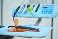 Dental chair with oral irrigator near doctor's unit with burs