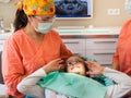 Dental checkup, being given to young girl, by female dentist with assistant Royalty Free Stock Photo