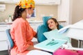 Dental checkup, being given to young girl, by female dentist with assistant Royalty Free Stock Photo