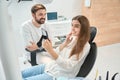 Dental clinic customer admiring her front upper teeth after whitening Royalty Free Stock Photo