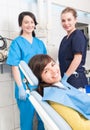 Dental clinic with female dentist, assistant and patient Royalty Free Stock Photo