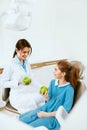 Dental Clinic. Female Dentist And Little Patient Eating Apple