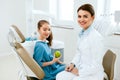Dental Clinic. Female Dentist And Little Patient Eating Apple