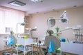 Dental clinic interior design with several dentists chair and tools. Modern dental clinic office with green chairs. Dental office Royalty Free Stock Photo