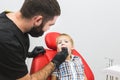 Dental clinic. Reception, examination of the patient. Teeth care. Dentist treating teeth of little boy in dentist office Royalty Free Stock Photo