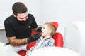 Dental clinic. Reception, examination of the patient. Teeth care. Dentist treating teeth of little boy in dentist office Royalty Free Stock Photo