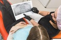 Dental clinic. Reception, examination of the patient. Teeth care. Female dentist in dental office talking with girl Royalty Free Stock Photo