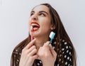 Dental concept. Young girl with red lips brushing teeth with toothbrush. Cropped photo. Royalty Free Stock Photo