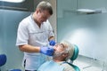 Dental doctor with senior patient.