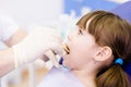 Dental examining being given to little girl by den