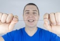 Dental floss close up. A man in front of a mirror brushes his teeth with flossing. The concept of proper oral care. Selective Royalty Free Stock Photo